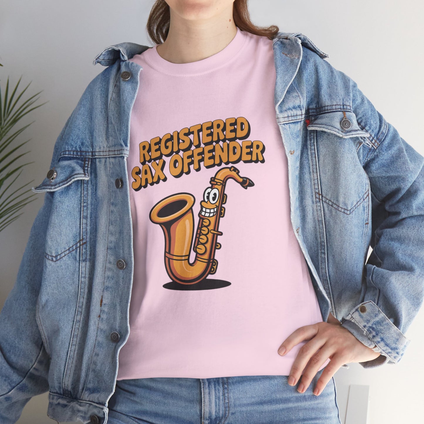 Model in denim jacket wearing pink Registered Sax Offender saxophone shirt – casual parody music graphic tee.