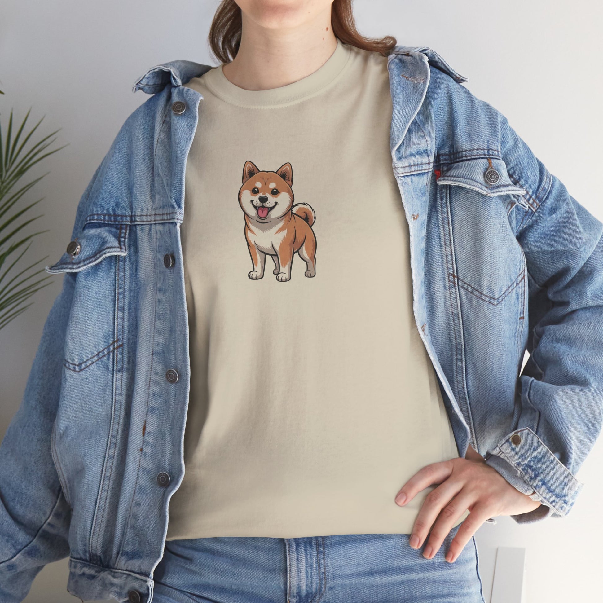Model in blue denim jacket wearing cream Shiba Inu dog graphic shirt – casual novelty graphic pet tee.