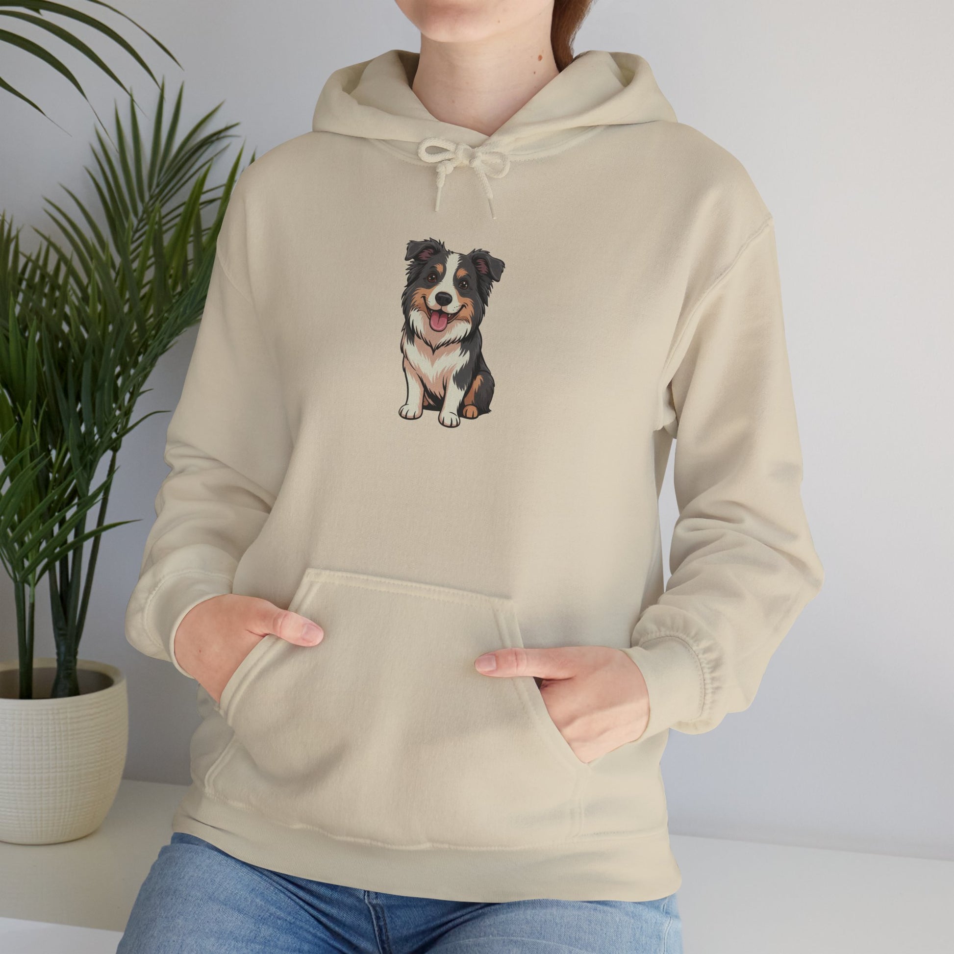 Model leaning against bench wearing cream Border Collie dog graphic hoodie – casual novelty dog lover hoodie.