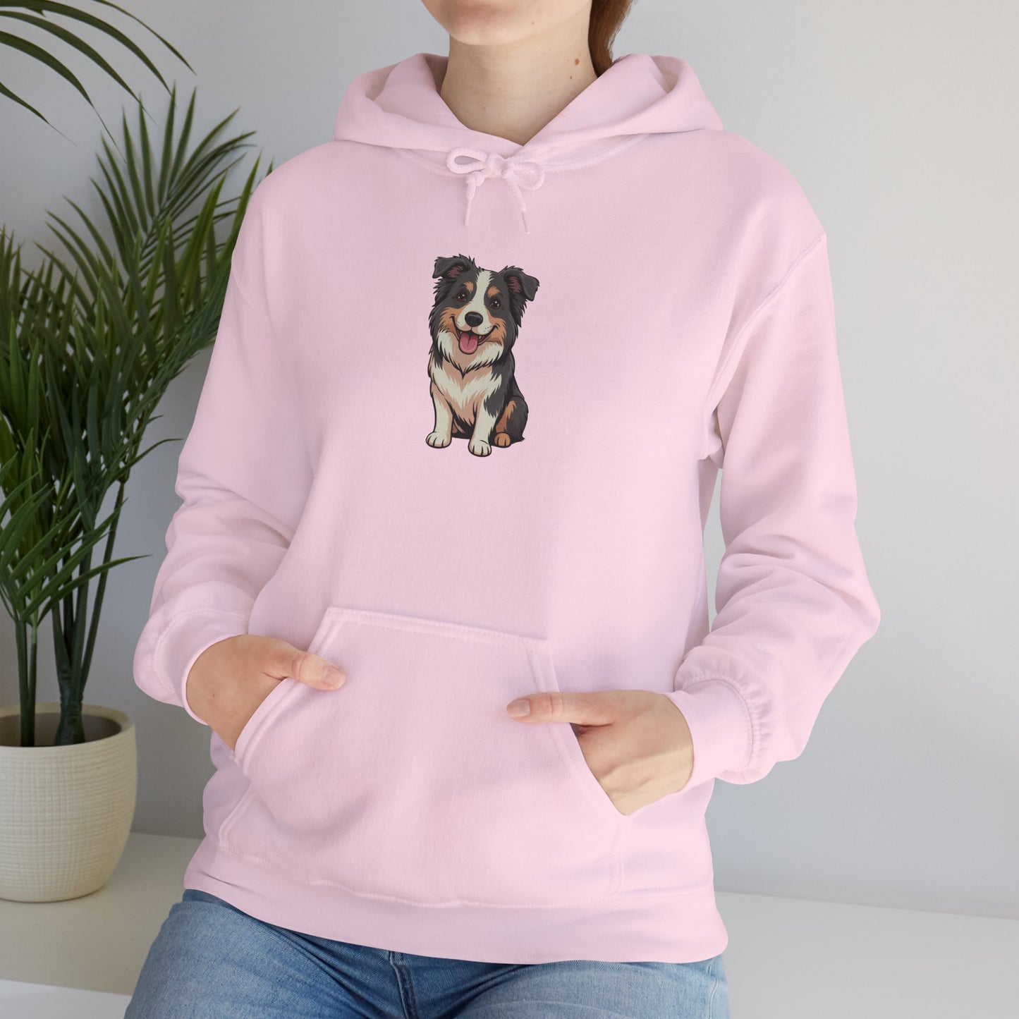 Model leaning against bench wearing pink Border Collie dog graphic hoodie – casual novelty pet lover hoodie.