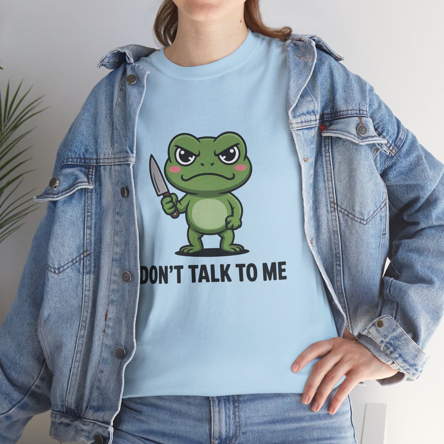 Model in blue denim jacket wearing light blue Don’t Talk to Me frog meme shirt – casual meme graphic tee look.