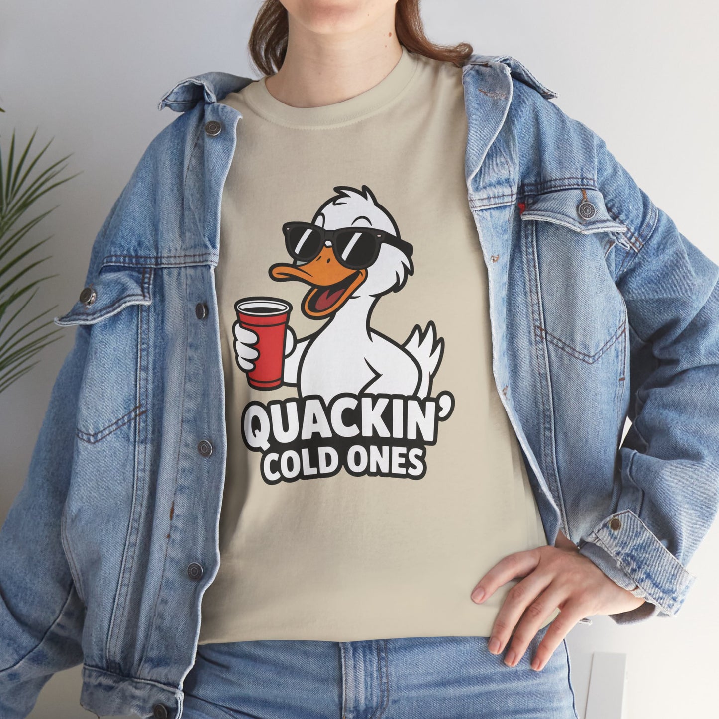 Model in blue denim jacket wearing cream Quackin’ Cold Ones duck meme shirt – casual novelty graphic t-shirt.
