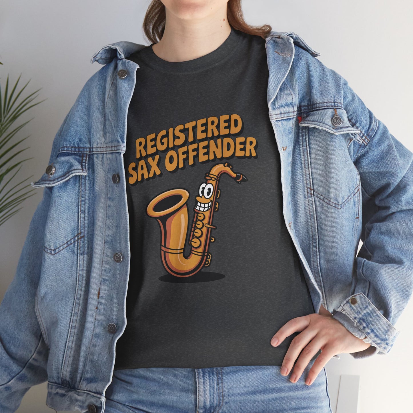 Model in denim jacket wearing dark grey Registered Sax Offender saxophone shirt – casual funny music parody tee.