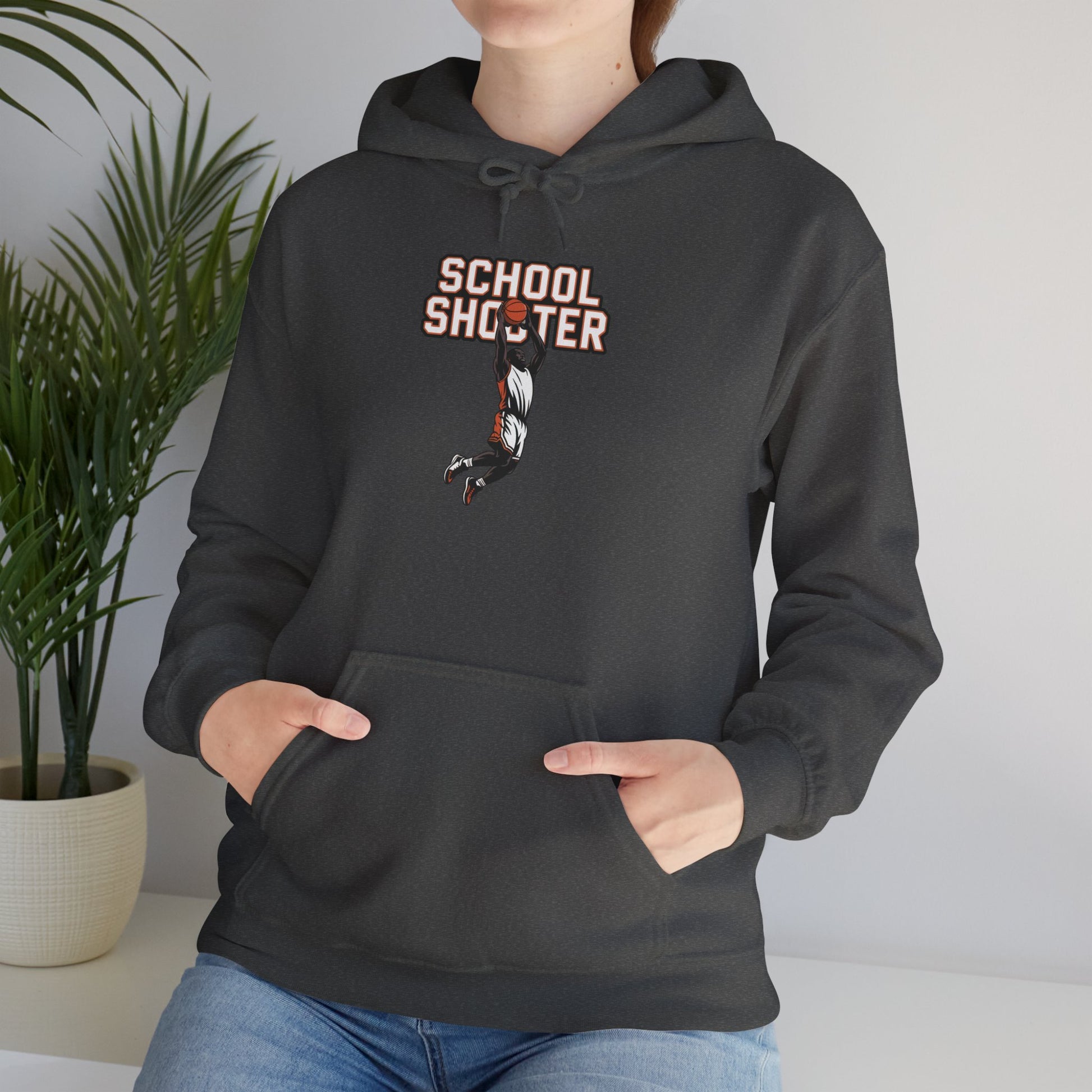 Model leaning against bench wearing dark grey Varsity Shooter hoodie – casual funny sports parody sweatshirt