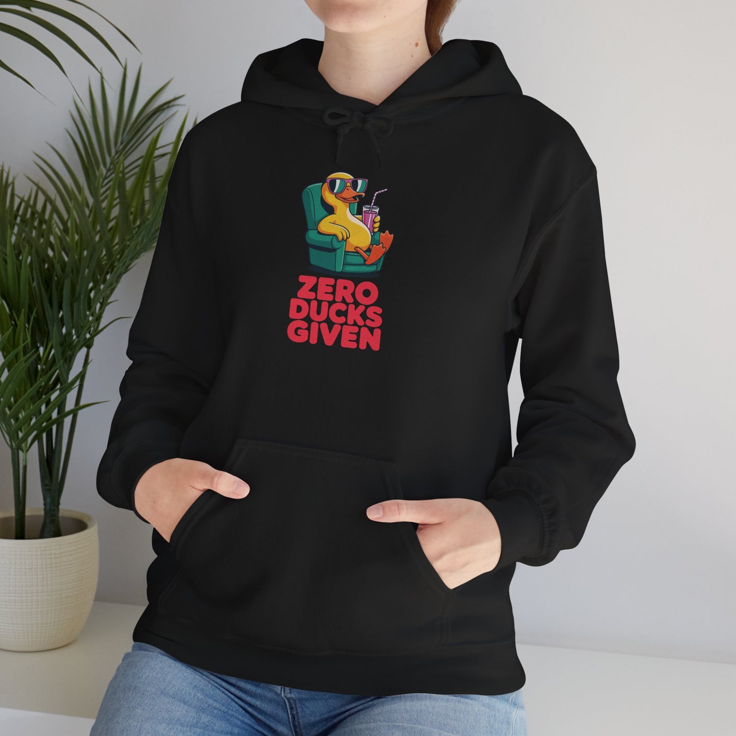 Model leaning against bench wearing black Zero Ducks Given hoodie – casual funny gag gift sweatshirt