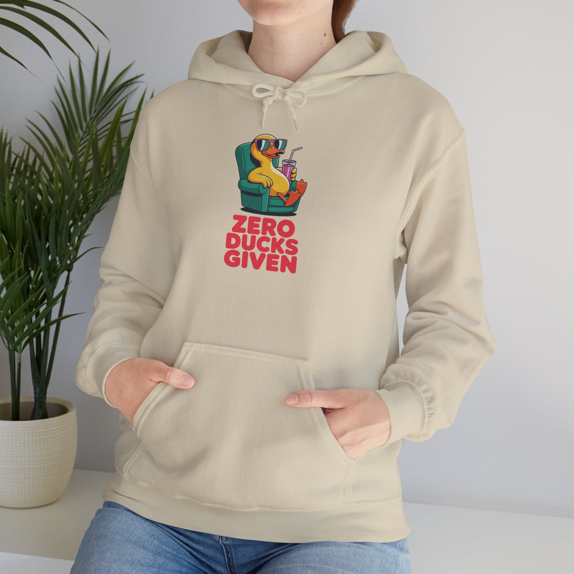 Model leaning against bench wearing cream Zero Ducks Given hoodie – casual funny animal lover sweatshirt