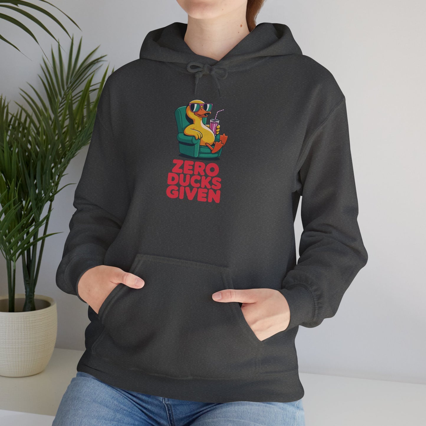 Model leaning against bench wearing dark grey Zero Ducks Given hoodie – casual funny gag gift sweatshirt