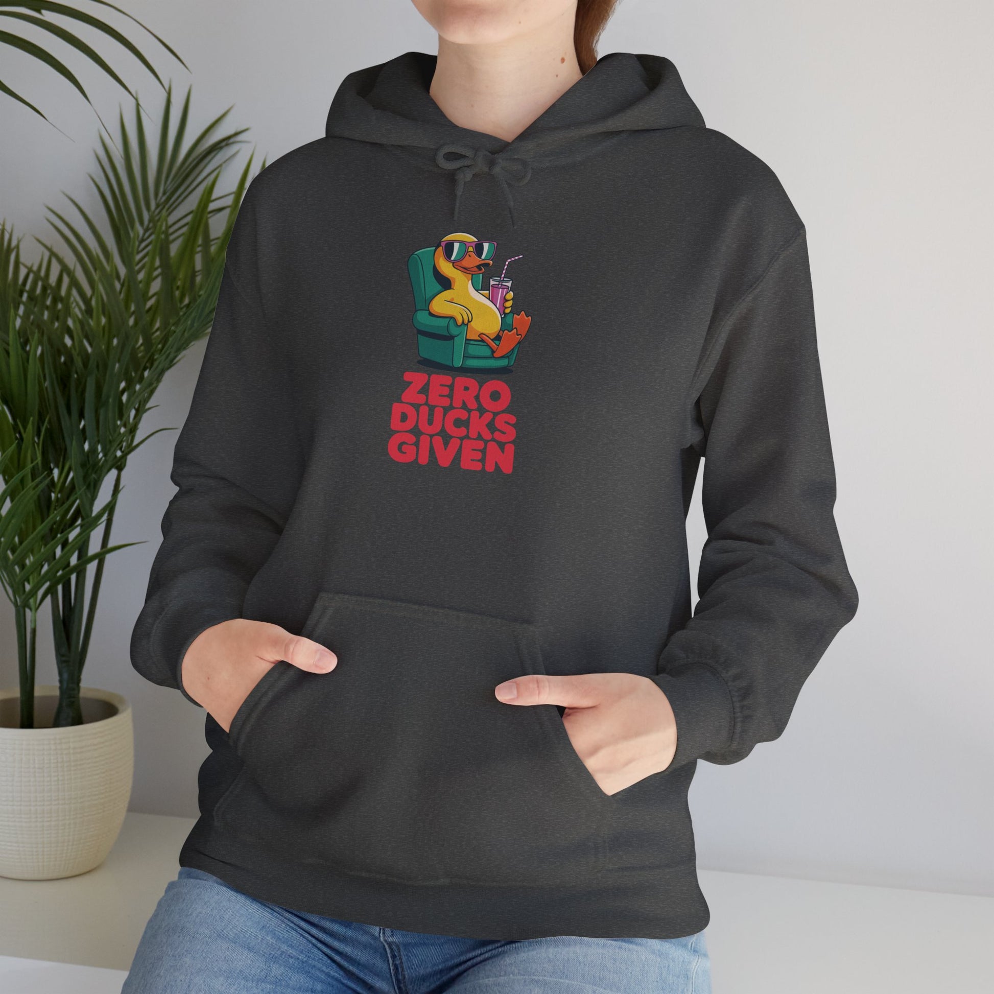 Model leaning against bench wearing dark grey Zero Ducks Given hoodie – casual funny gag gift sweatshirt