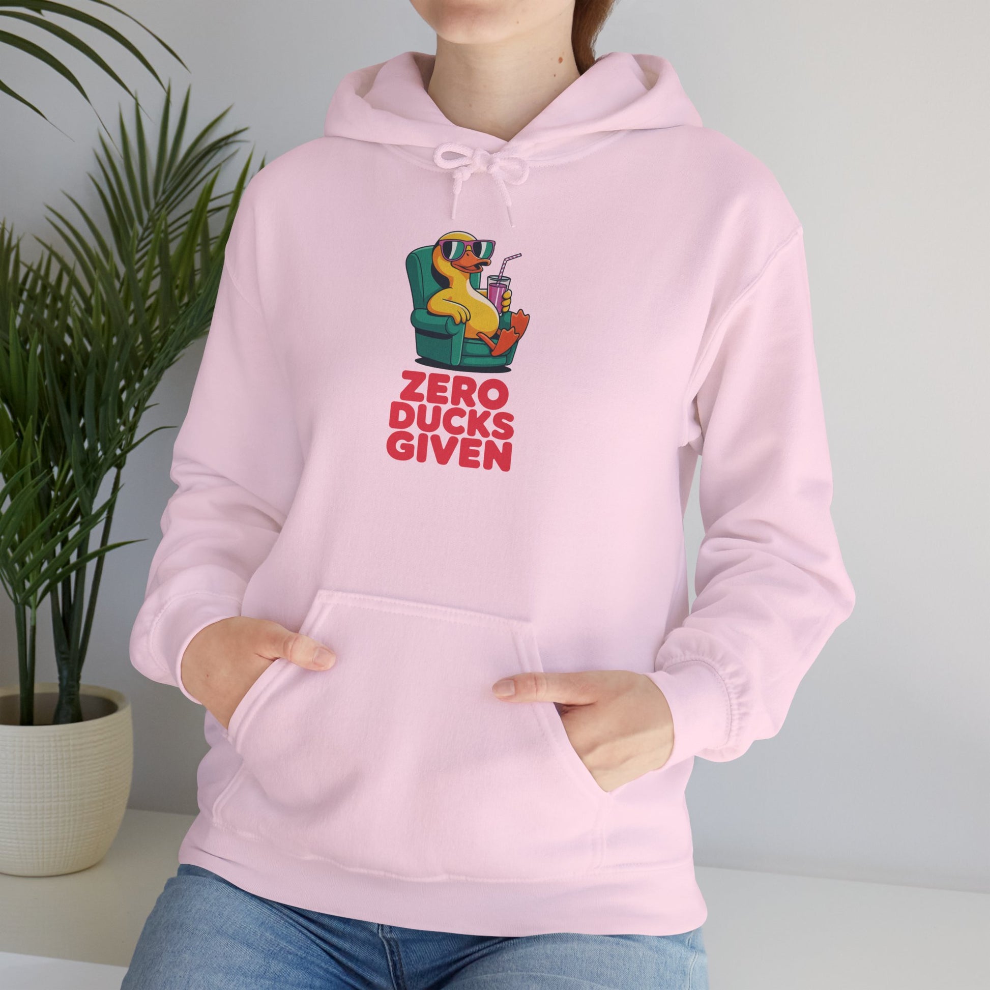Model leaning against bench wearing pink Zero Ducks Given hoodie – casual funny gag gift sweatshirt